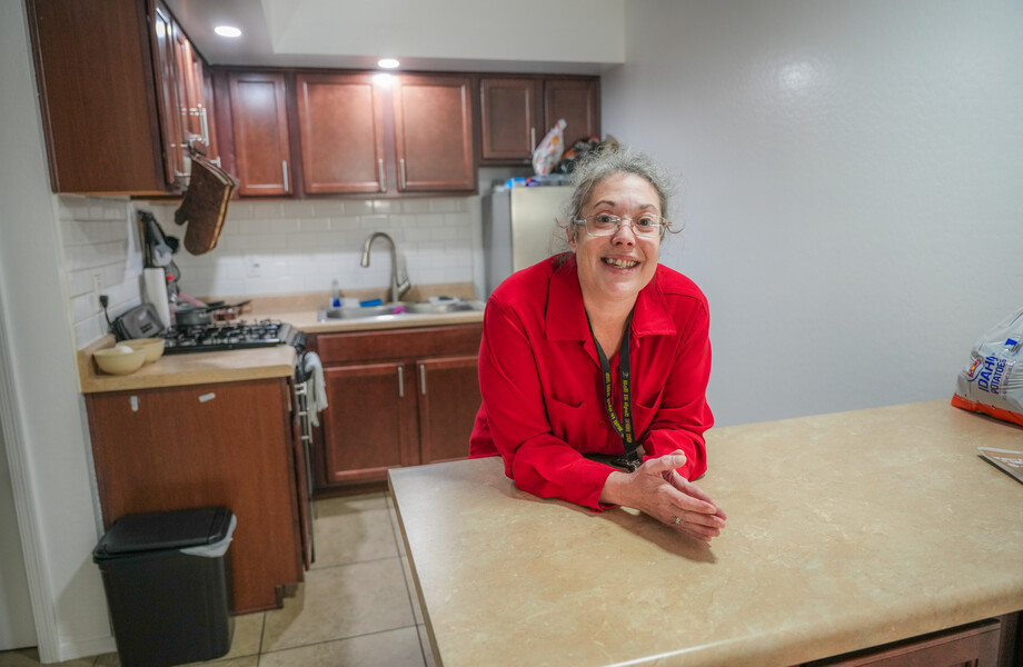 Carmela poses in her new apartment.