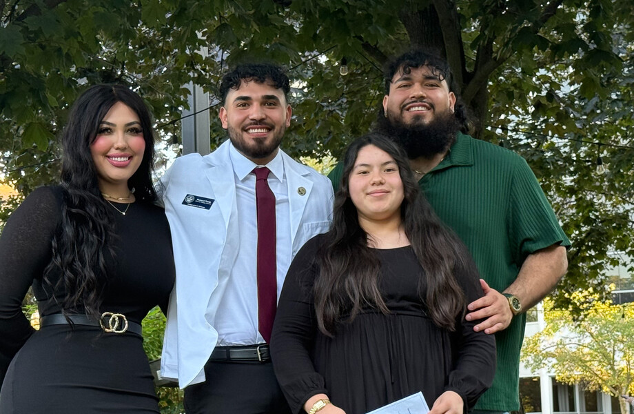 Russvel poses with his family after his white coat ceremony.