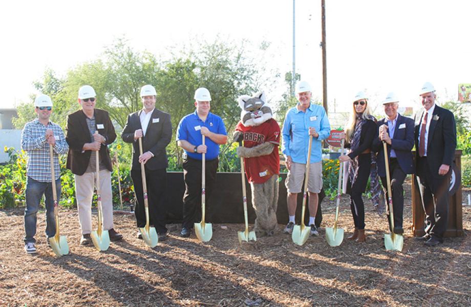 Local partners and supporters pose for a groundbreaking photo in SVdP's Urban Farm.