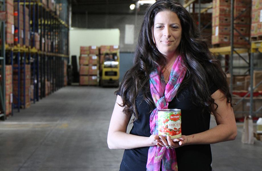 Jamie Bethune poses for a photo in SVdP Food Rec Warehouse