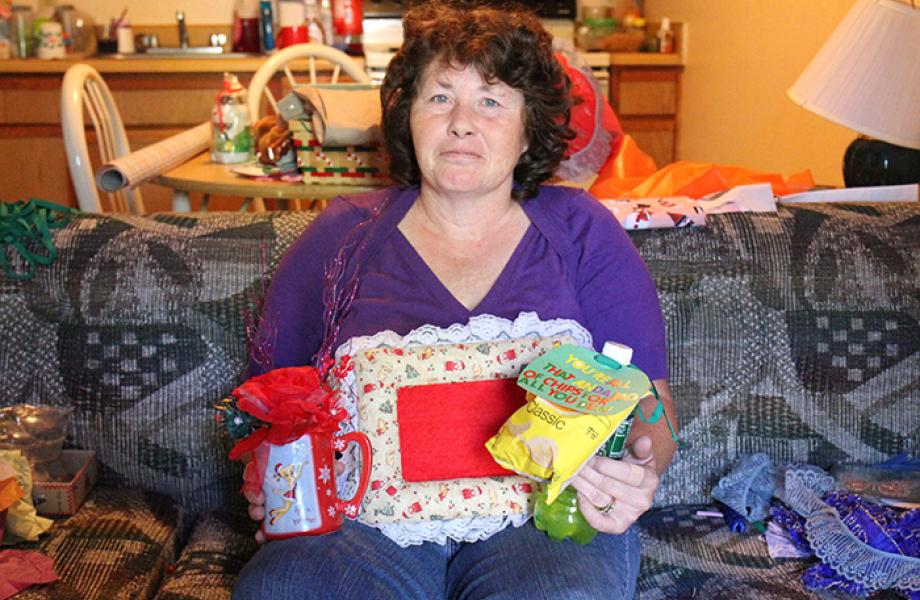 Sherry poses for a photo with her crafts.