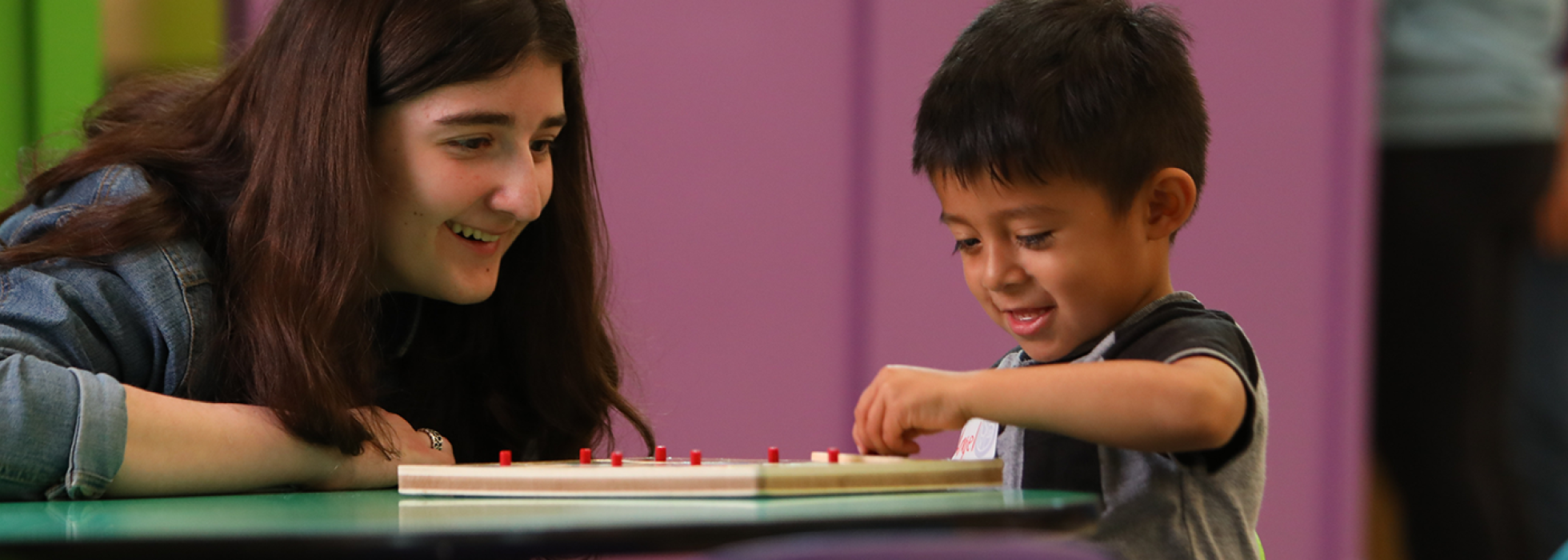 girl watching boy play a game