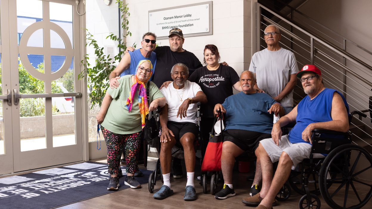 Group of Ozanam Manor residents posing together in the lobby