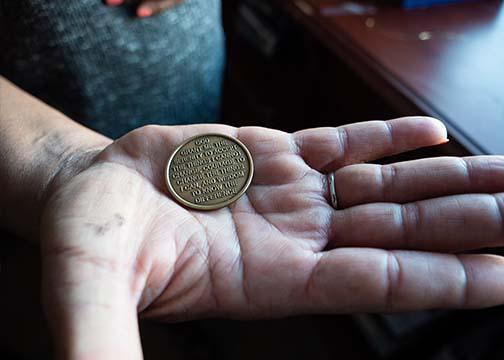 Woman holding AA chip in her outstretched hand