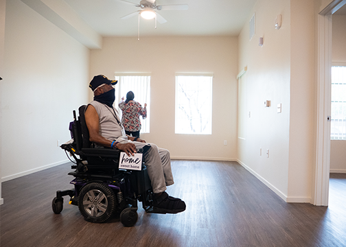 Man in wheelchair in empty apartment