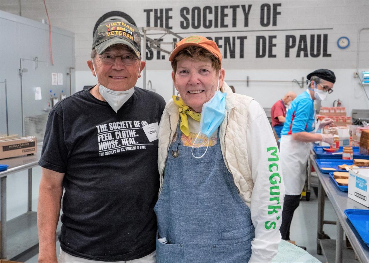 Man and woman posing for the camera in the SVdP kitchen