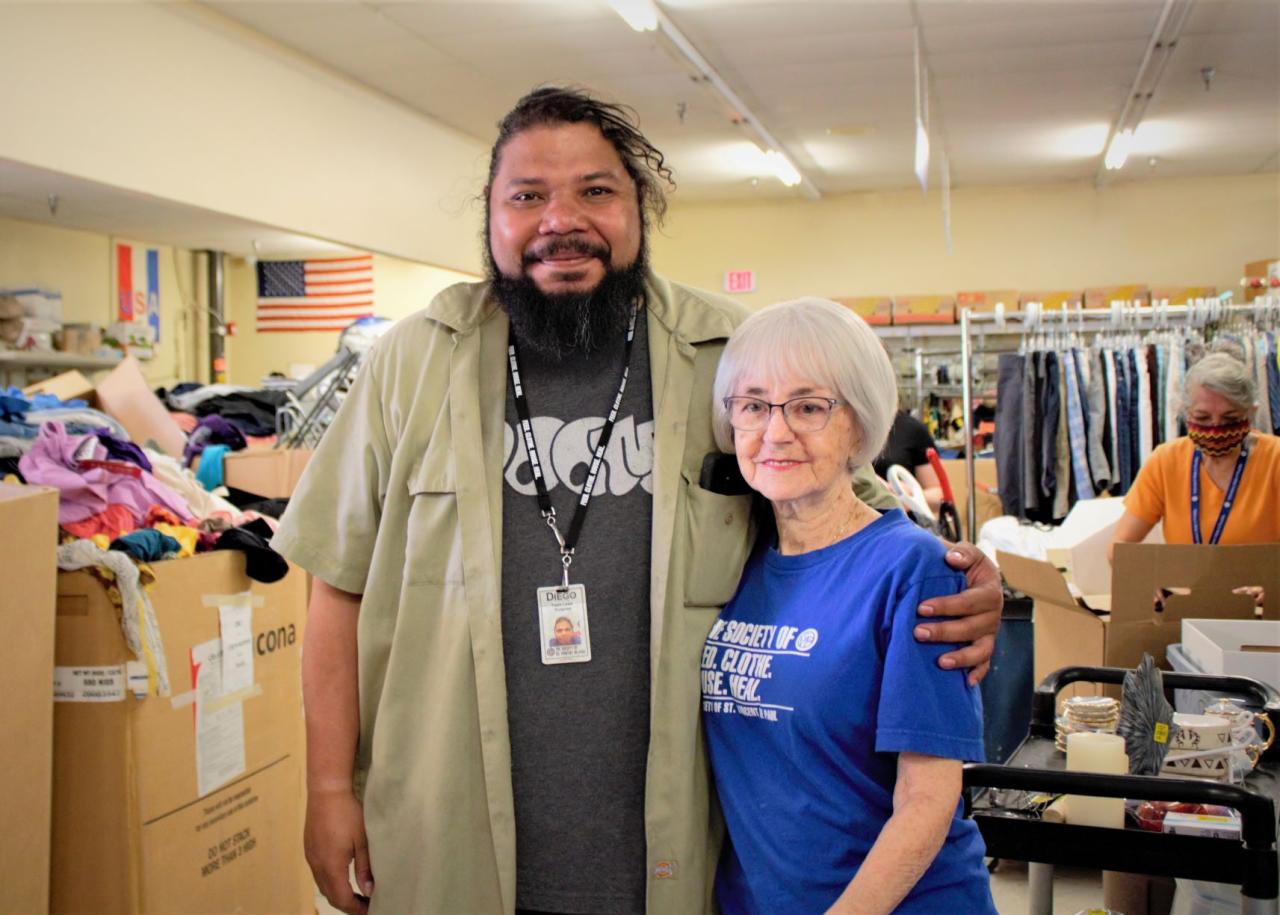 Man and woman posing for the camera in a thrift store