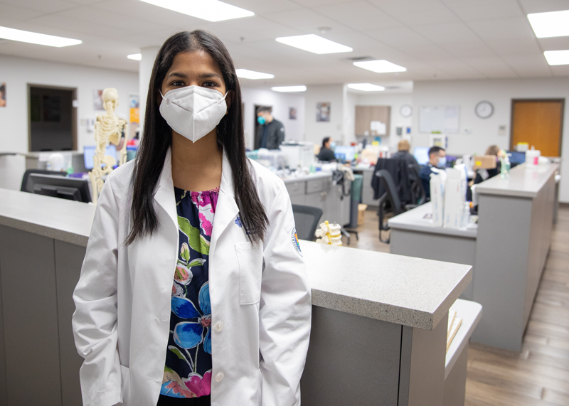 Woman in mask smiling at the camera