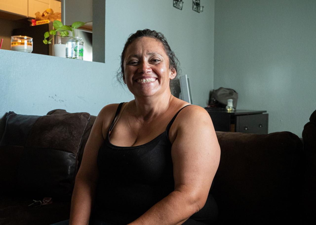 Woman sitting on a couch smiling