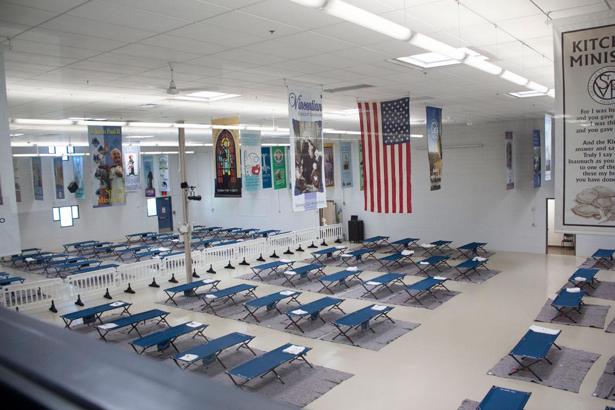 Wide shot of a room full of cots