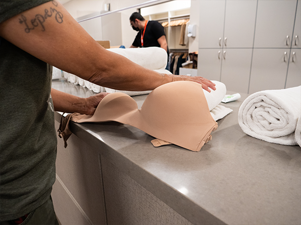 Woman grabbing a bra on a counter