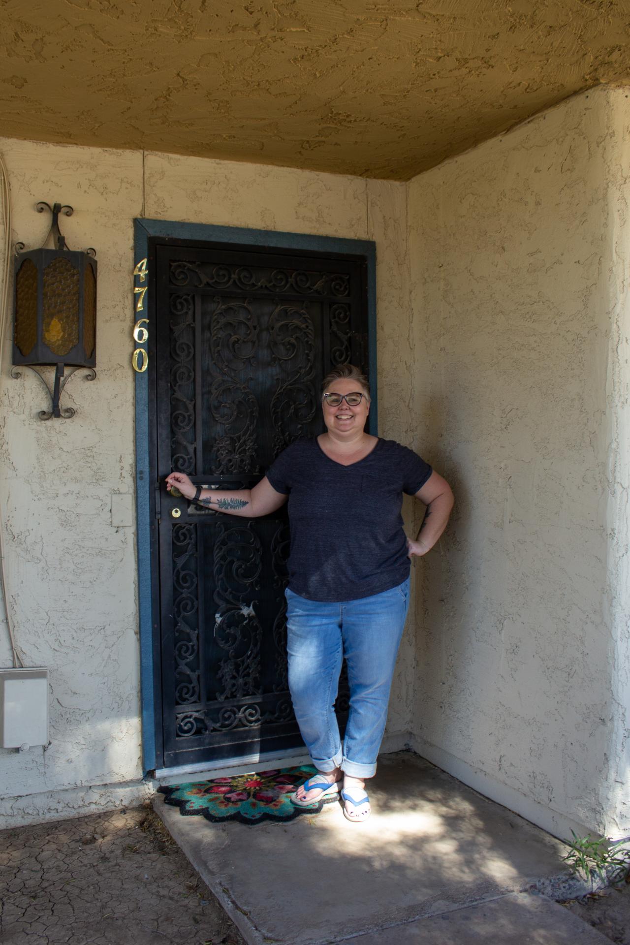 Woman standing in front of her door