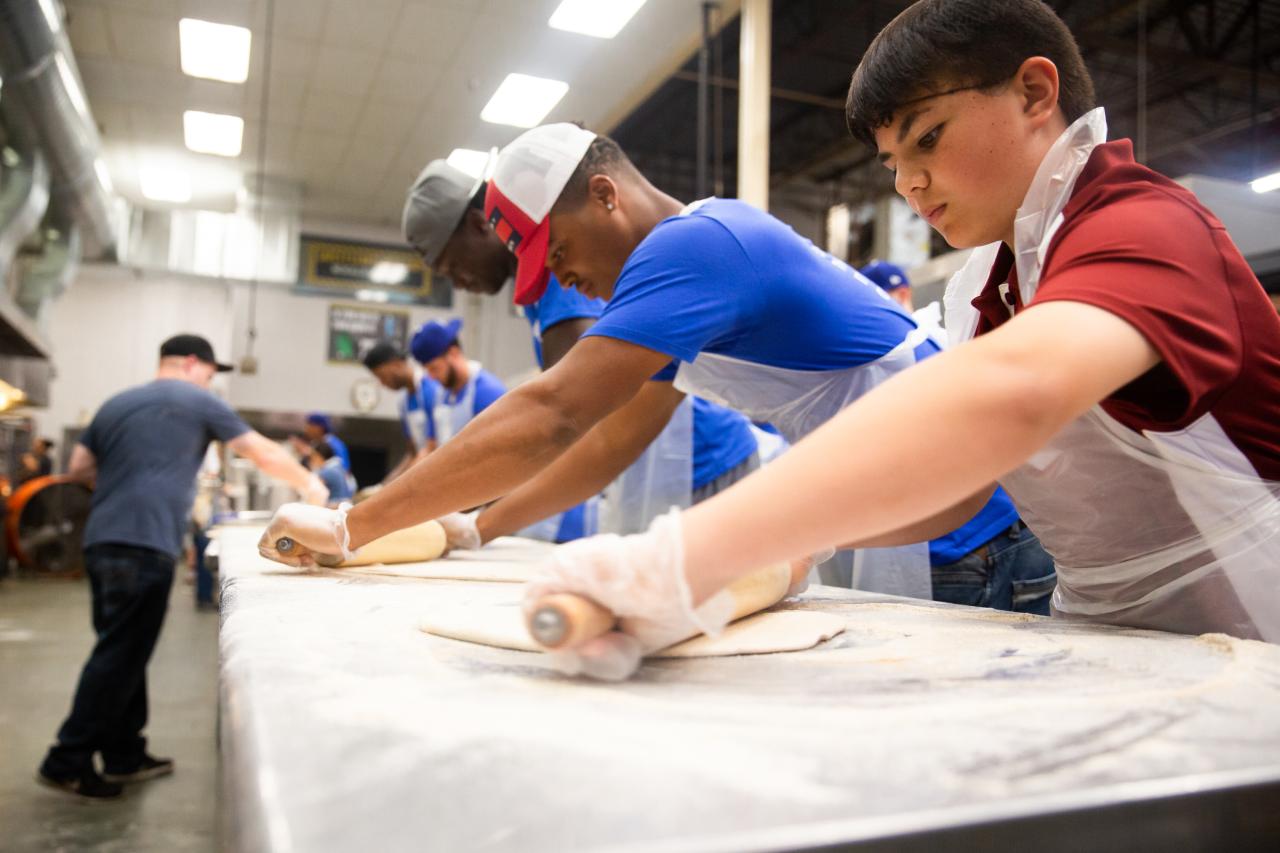 volunteers making pizza