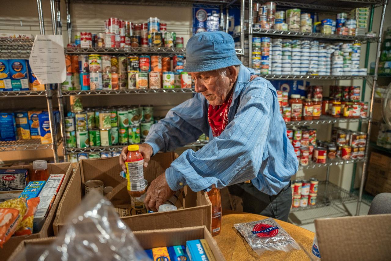 A Vincentian volunteer packs a food box at St. Matthew's parish SVdP food bank.