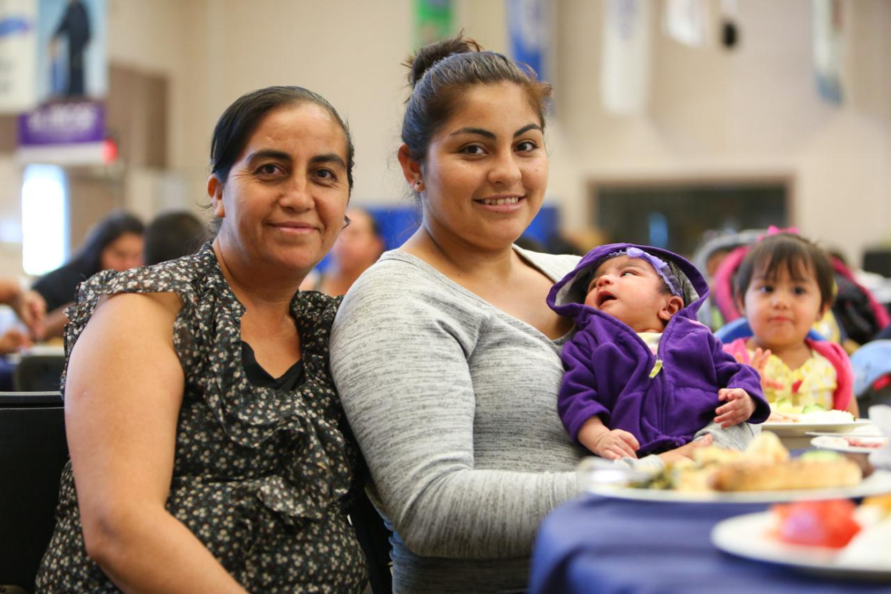 Two women and a child sitting at a table in the St. Vincent de Paul family dining room