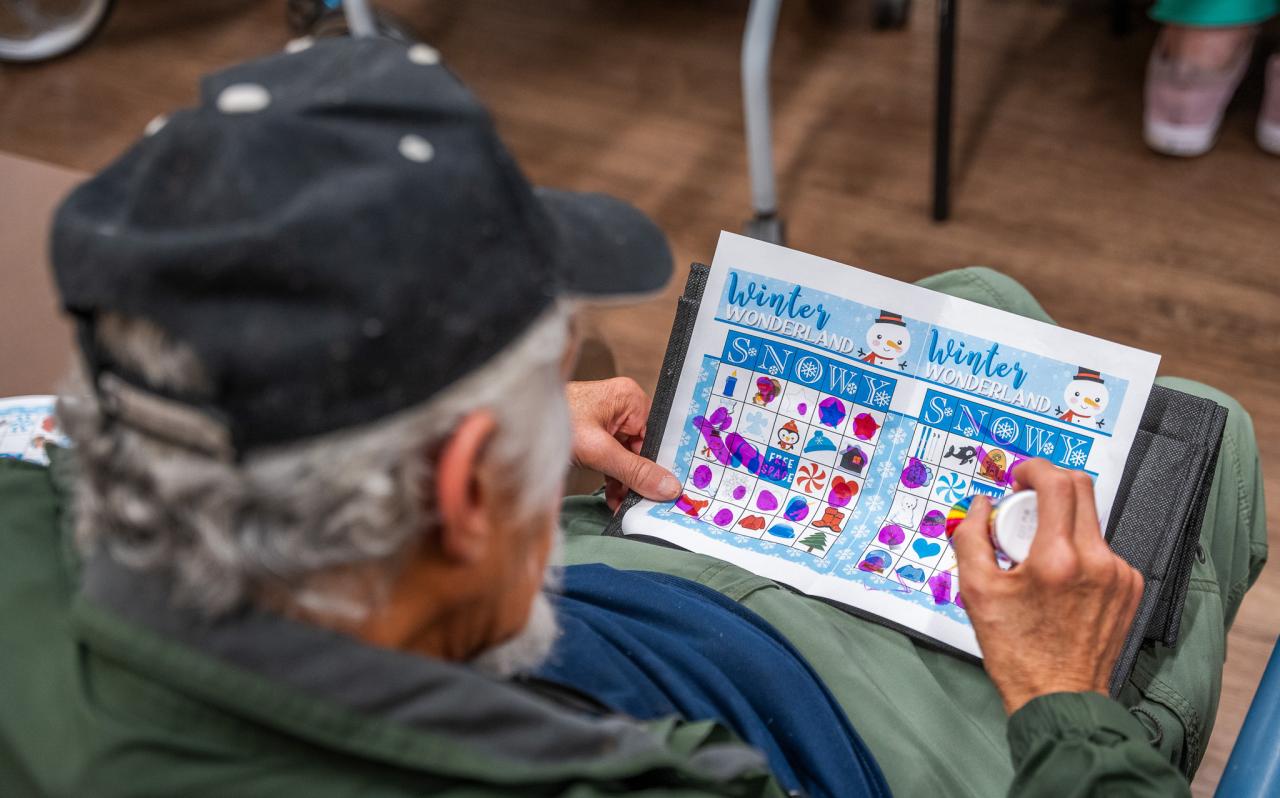 A guest watches his BINGO card during a game in Oz.