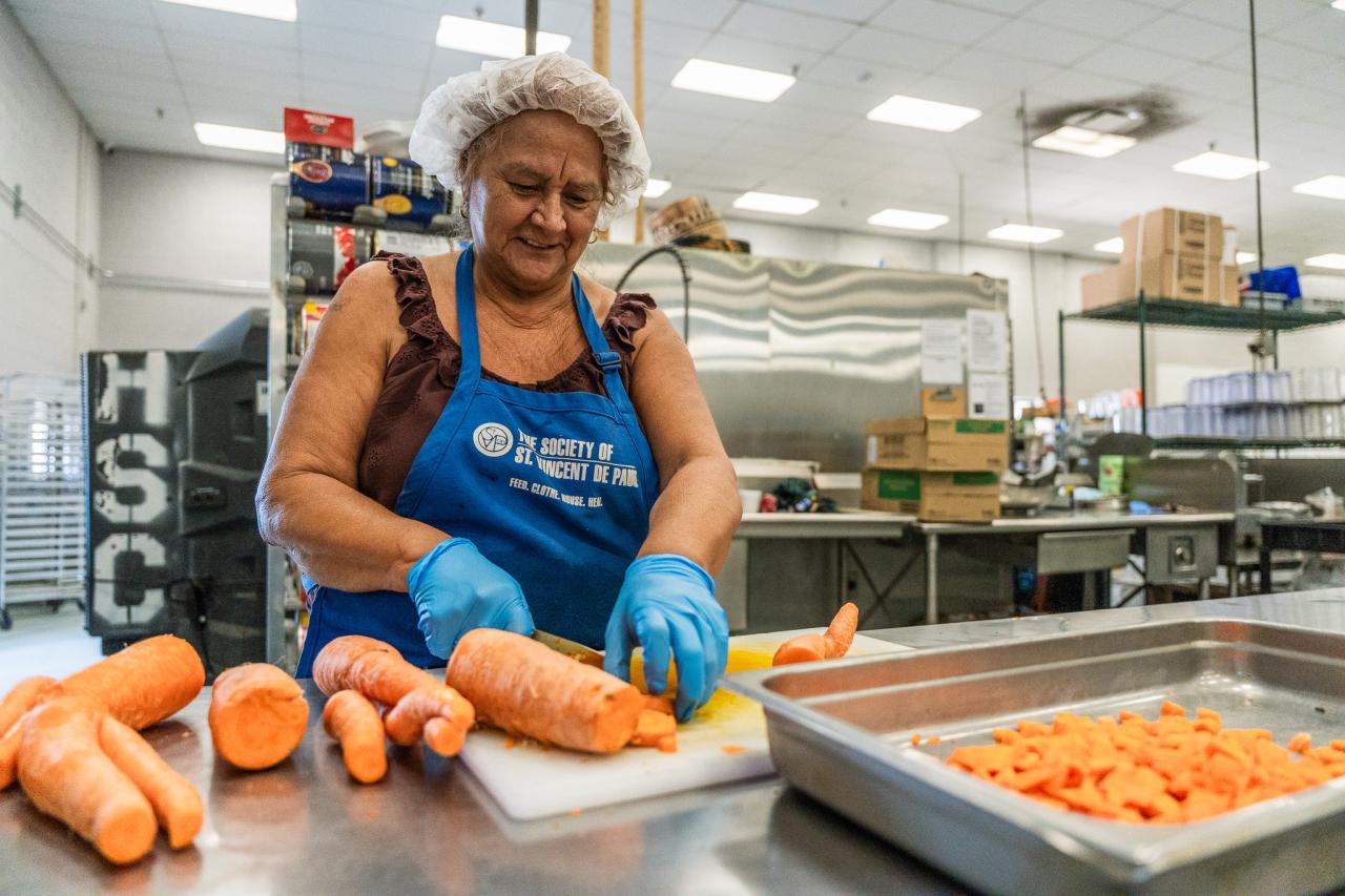 Anita chops vegetables in the central kitchen.