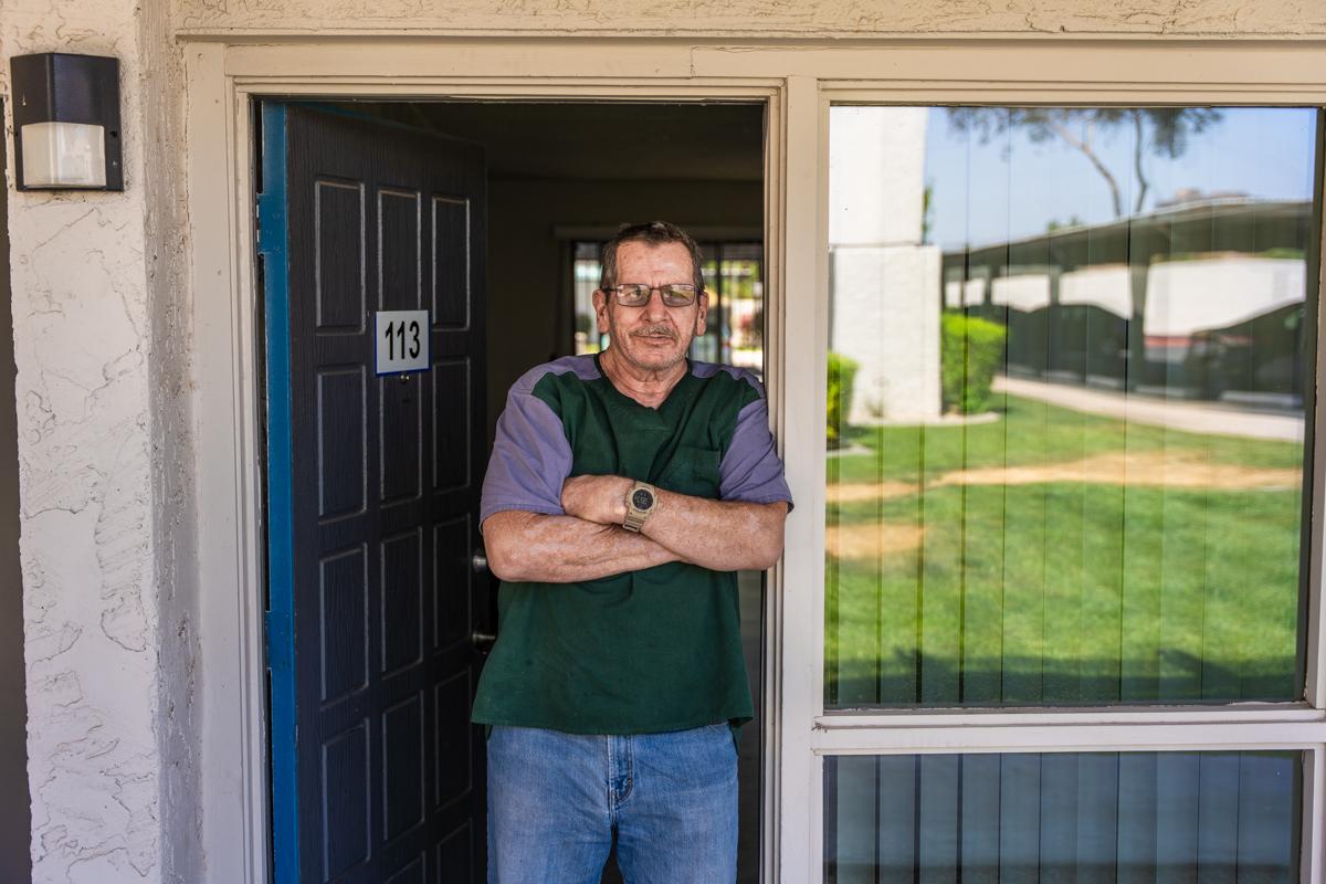 Christopher in his apartment's doorway.