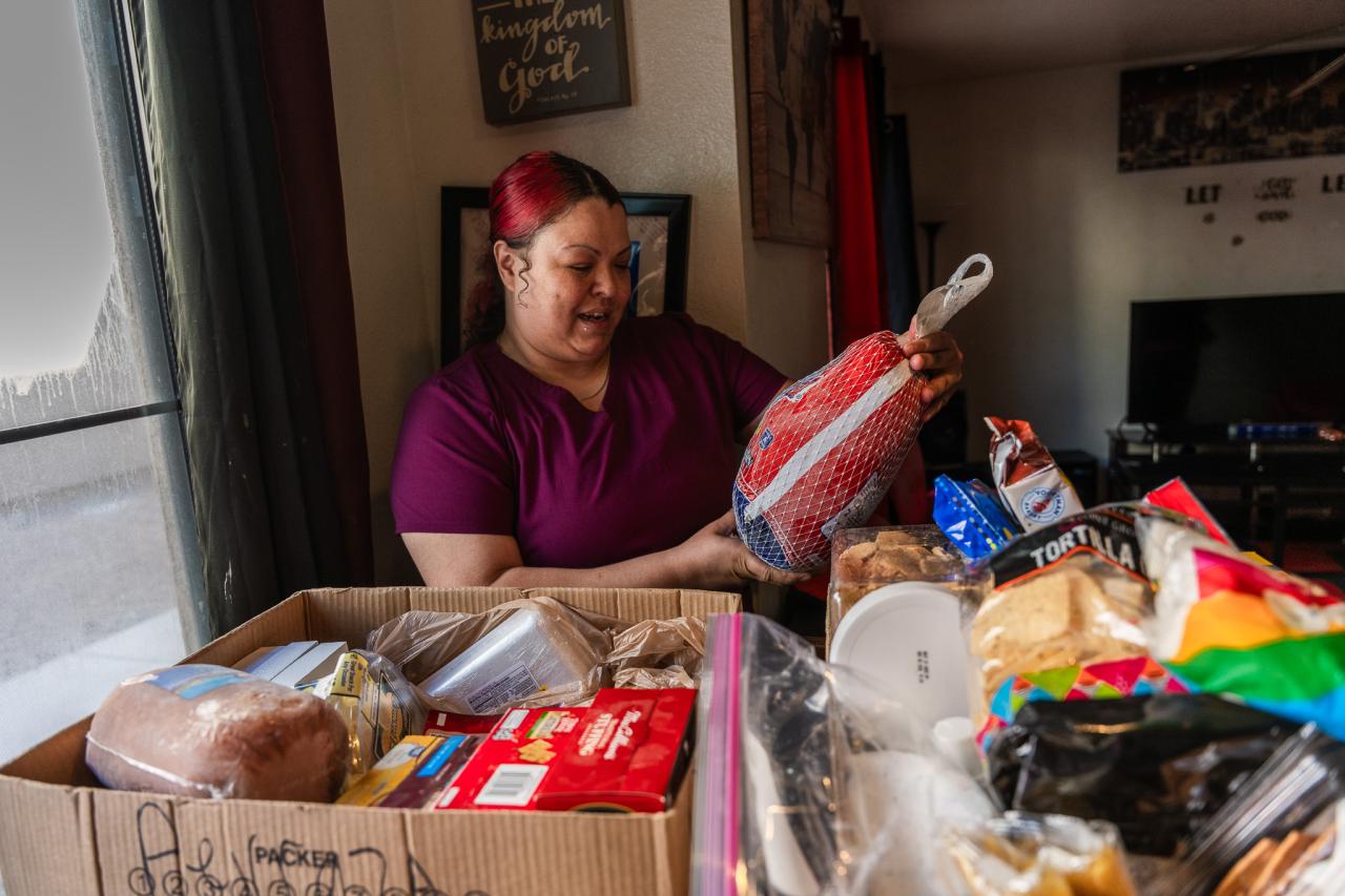 Angela examines the turkey from the food box.