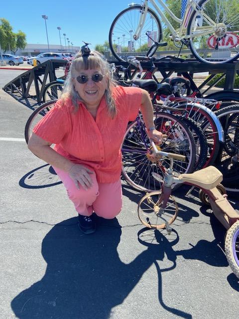 Woman posing next to a tricycle