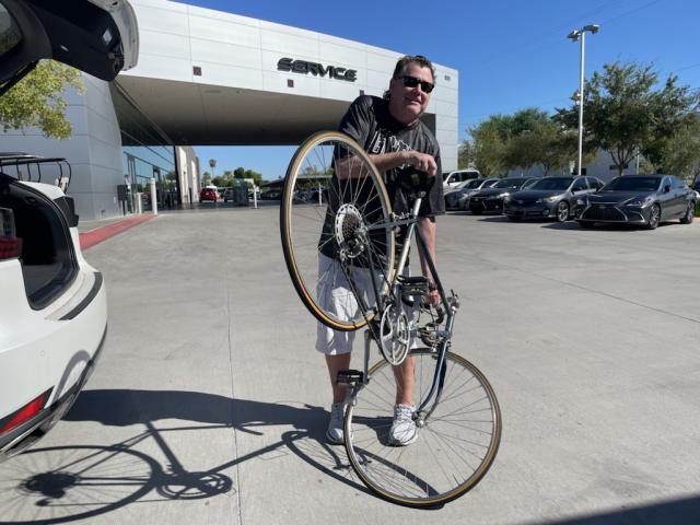 Man holding up a bike