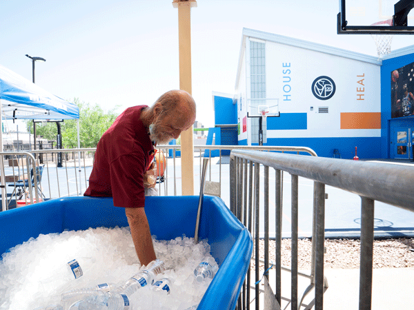 A dining room guest stocks up on water during SVdP heat relief services.